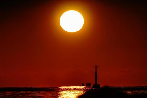 <素材>秋の海に静かに沈む夕日と灯台 <素材>秋の海に静かに沈む夕日と灯台の写真