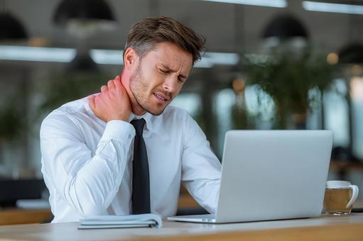 疲れた首をマッサージする男性 疲れた首をマッサージする男性の写真