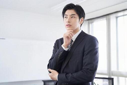 Japanese male businessman thinking in the conference room Japanese male businessman thinking in the conference room