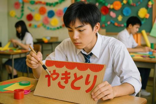 看板を描く男子高校生 看板を描く男子高校生の写真