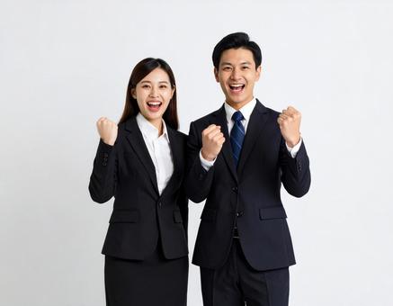 ガッツポーズする若手男女ビジネスマン ガッツポーズする若手男女ビジネスマンの写真