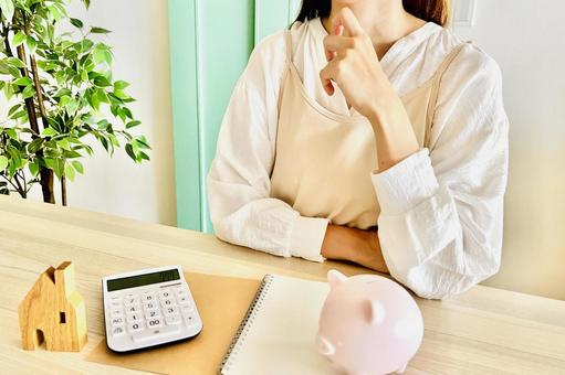 家のリビングでお金について悩む女性 家のリビングでお金について悩む女性 家計,助成金,補助金の写真素材
