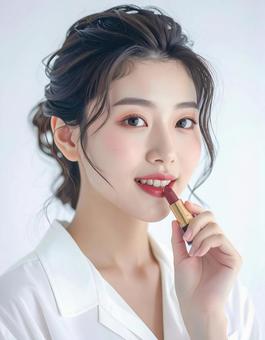 リップを塗る若い女性の美容ポートレート リップを塗る若い女性の美容ポートレートの写真