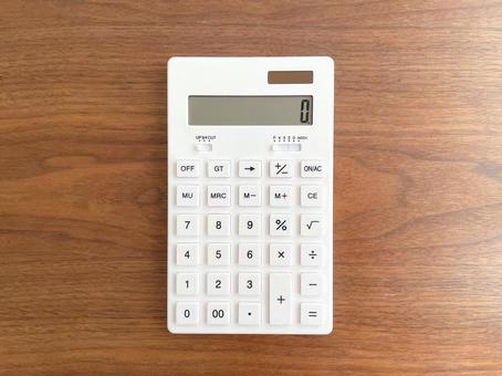 White calculator on a wooden table, JPG White calculator on a wooden table, JPG