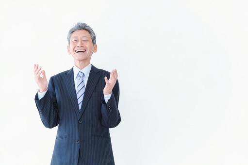 笑顔で意見を主張する経営者の男性 笑顔で意見を主張する経営者の男性 ビジネスマン,白背景,高齢者の写真素材