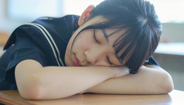教室で寝る女子高生 教室で寝る女子高生の写真