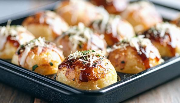 たこ焼き機で焼いているたこ焼き たこ焼き機で焼いているたこ焼きの写真