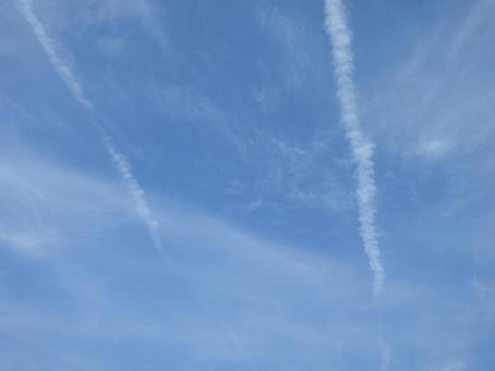 Two contrails stretching across the blue sky, JPG