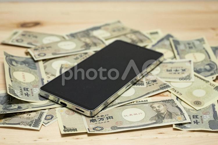 おもちゃのお金　スマートホン 紙幣,富,貯蓄の写真素材