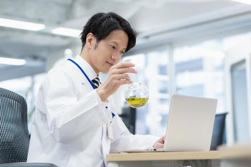 実験をする白衣の若い男性研究者 実験をする白衣の若い男性研究者 研究,実験,サイエンスの写真素材