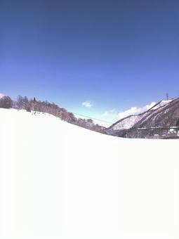快晴のスキー場、真白なゲレンデと遠くの山 スキー場,背景,冬の写真素材
