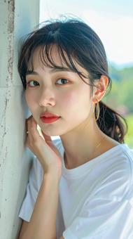 白いTシャツの女性が壁際でポーズをとる 白いTシャツの女性が壁際でポーズをとるの写真