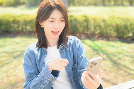 A woman getting angry at her smartphone, JPG A woman getting angry at her smartphone, JPG