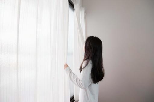白いカーテンを開ける女性 白いカーテンを開ける女性 カーテン,女性,後ろ姿の写真素材