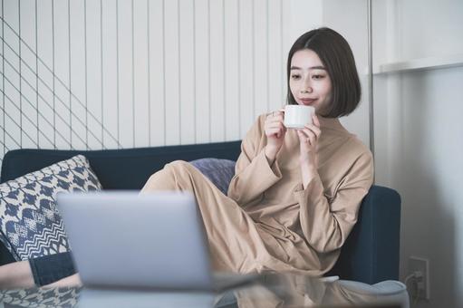 A woman looking at the screen of a stay home computer, stay home, computer, pc, JPG