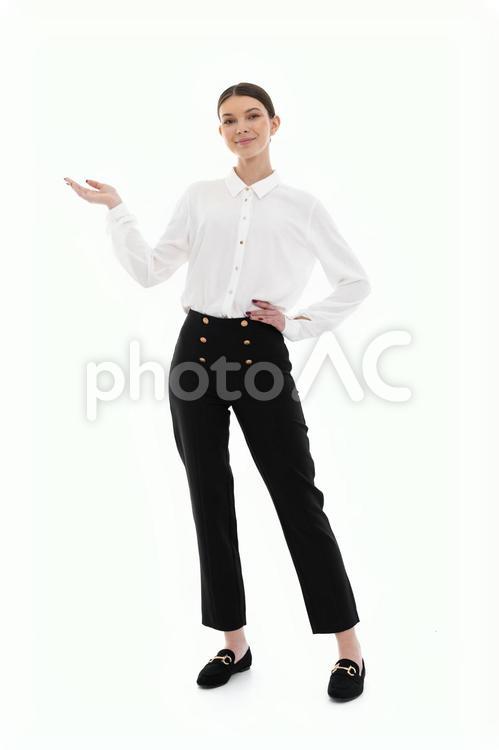 左手を腰に当てポーズする白いシャツの女性 女性,微笑む,笑顔の写真素材