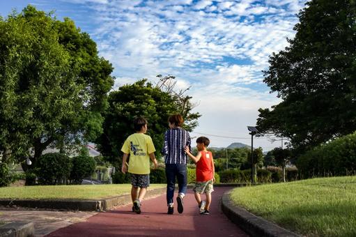 <Material> Parent and child walking on a promenade in a park at dusk, JPG