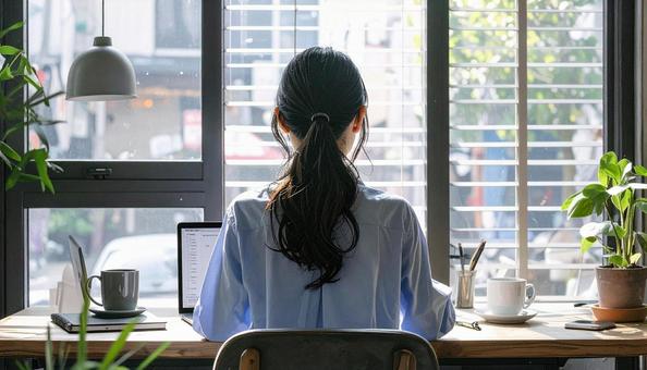 カフェで仕事をするフリーランス女性 カフェで仕事をするフリーランス女性の写真