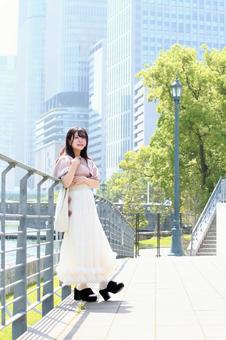 川沿いで景色を眺める女性 川沿いで景色を眺める女性の写真
