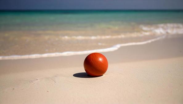 美しいビーチに赤いボールの写真