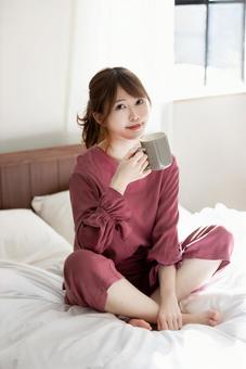寝室でくつろぐ女性 寝室でくつろぐ女性の写真