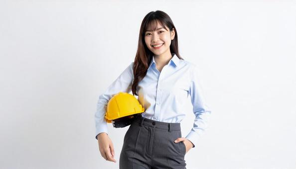 ヘルメットを抱え笑顔の若い日本人女性 ヘルメットを抱え笑顔の若い日本人女性の写真