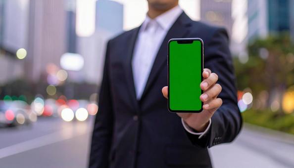 携帯画面を見せているビジネスマン 携帯画面を見せているビジネスマンの写真