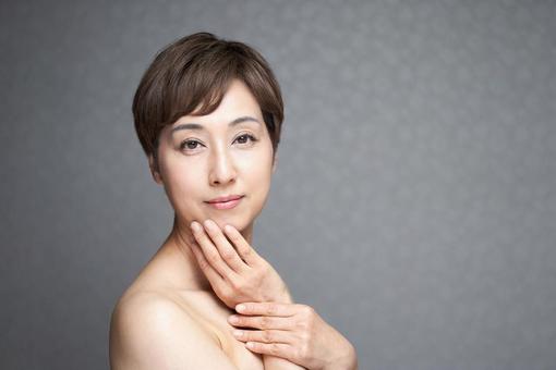 Middle-aged Japanese woman putting her hand on her chin, JPG Middle-aged Japanese woman putting her hand on her chin, JPG