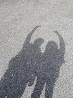 A relaxing date. A couple taking pictures of their shadows., a couple, a date, lovey dovey, JPG