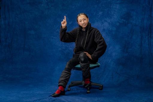 上を指差す女性_スタジオ撮影 女性,メガネ,三つ編みの写真素材