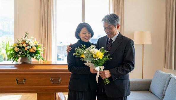 棺に花束を供えるミドルの男女 棺に花束を供えるミドルの男女の写真