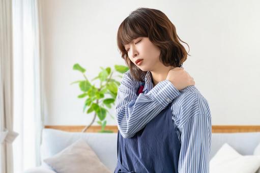 肩こりに悩むエプロン姿の女性 肩こりに悩むエプロン姿の女性 人物,女性,肩こりの写真素材