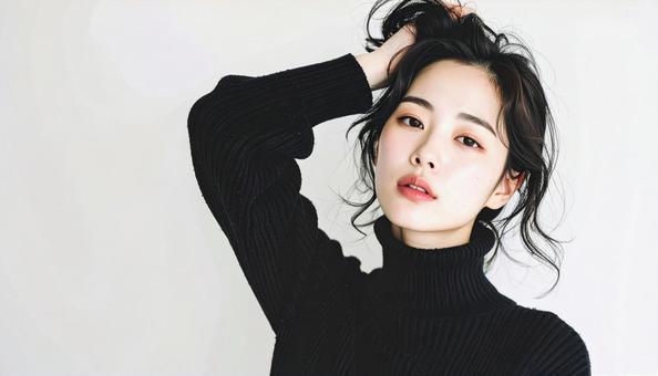 ヘアをかき上げる女性のモダンな表情の写真