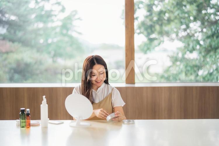 鏡の前でメイクする女性（クリーム） 保湿,スキンケア,クリームの写真素材