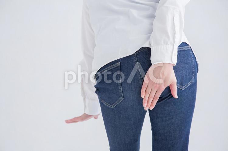 お尻をおさえる女性 おなら,下痢,痔の写真素材