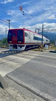 晴天の踏切を通過する赤い電車 晴天の踏切を通過する赤い電車 電車,踏切,鉄道の写真素材