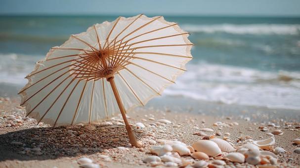 貝殻と白い和傘が彩る夏の砂浜の風景 貝殻と白い和傘が彩る夏の砂浜の風景の写真