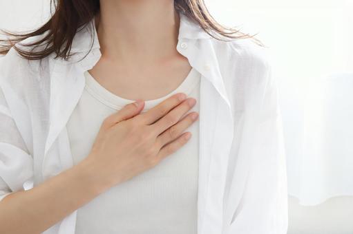 胸に手を当てる女性 心配 胸に手を当てる女性 心配の写真