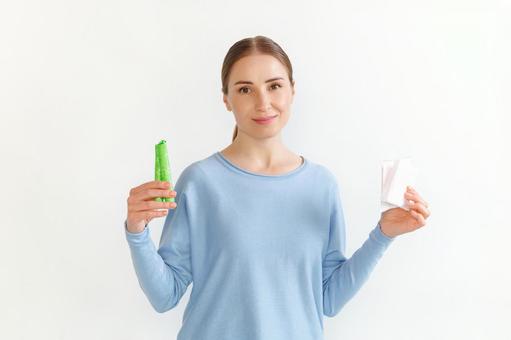 生理用ナプキンとタンポンを手に持つカメラ目線の女性 生理,月経,女性の写真素材