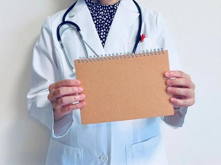 A female doctor holding a brown blank notebook, JPG A female doctor holding a brown blank notebook, JPG