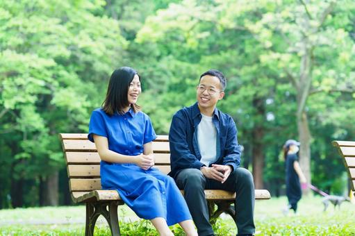 Young couple chatting on a park bench, JPG Young couple chatting on a park bench, a couple, walk, a lover, JPG