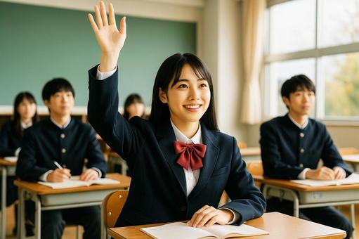 教室で手を挙げる女子高校生の写真
