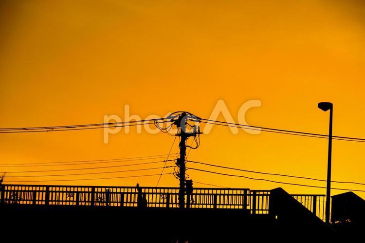夕焼けと電線と建物のシルエット 電柱,電線,シルエットの写真素材