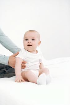 Baby with a surprised face sitting up supported, JPG Baby with a surprised face sitting up supported, JPG