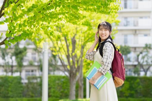 キャンパスを歩く女子大学生 キャンパスを歩く女子大学生の写真