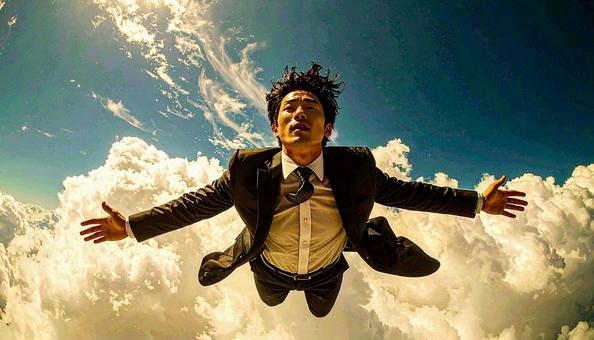 空を飛ぶビジネスマン 空を飛ぶビジネスマンの写真