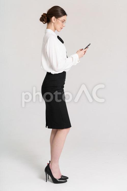 スマホを見る横向きのメガネ女性 女性,スマートフォン,持つの写真素材