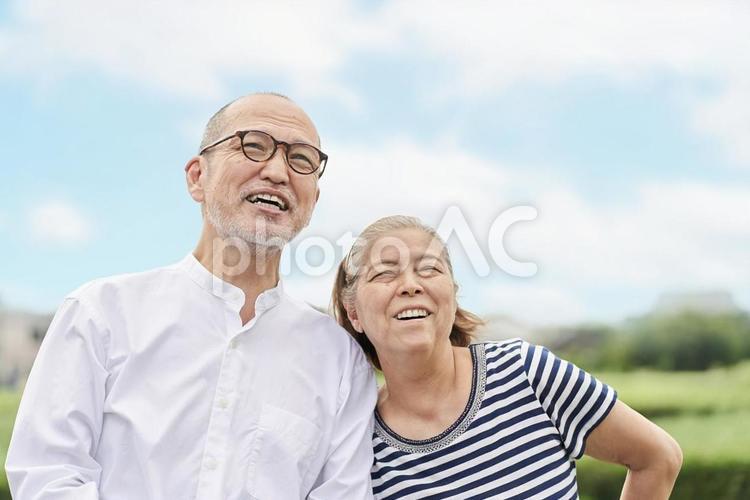 Elderly couple standing with a smile against the blue sky, JPG Elderly couple standing with a smile against the blue sky, senior citizens, couple, blue sky, JPG