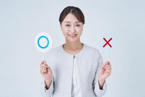 マルとバツのプレートを持つ女性 マルとバツのプレートを持つ女性 選択,選択肢,クイズの写真素材