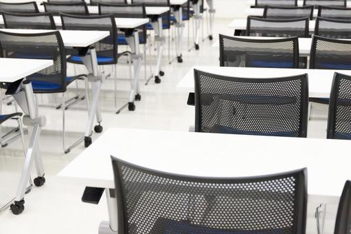 Close-up of long desks and chairs in a simple white conference room, conference room, training, meeting, JPG